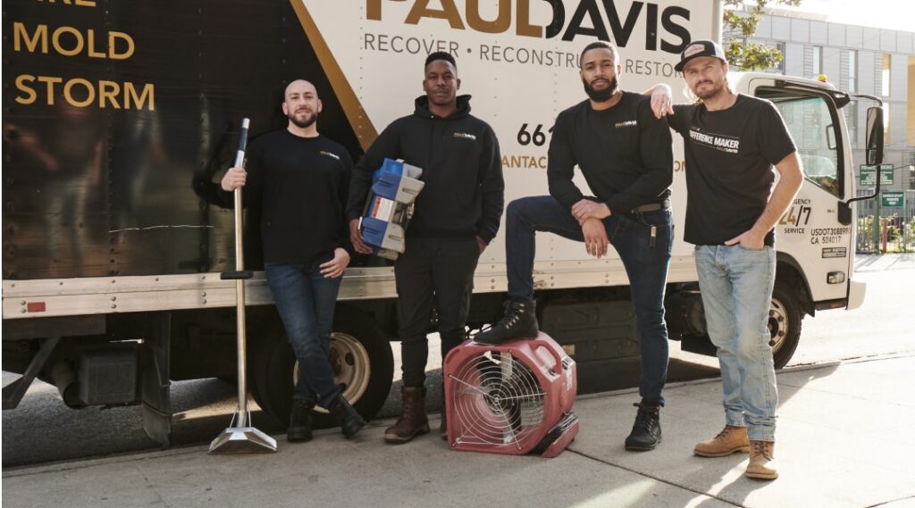 Paul Davis Restoration of West Orange County CA emergency restoration team standing in front of service truck with water damage drying equipment and cleanup tools